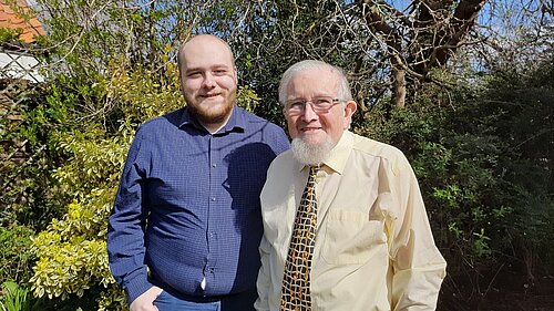 Connor Docwra and Gareth Wilson Connor Docwra stood on the left with Gareth Wilson on the right, in front of treet and bushes